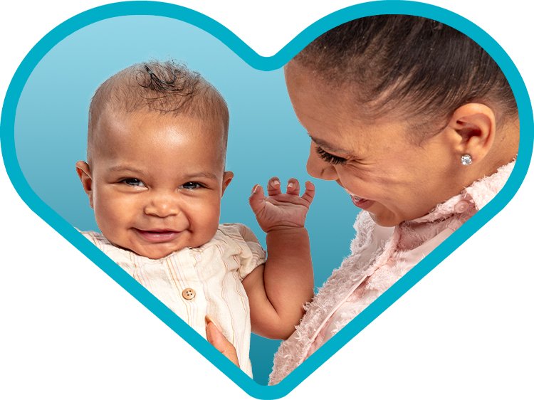 Photo of an AA mother and smiling baby in a MLKCH blue heart
