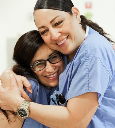 Two nurse hugging