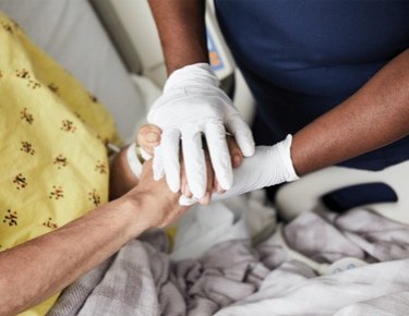 patient and staff holding hands