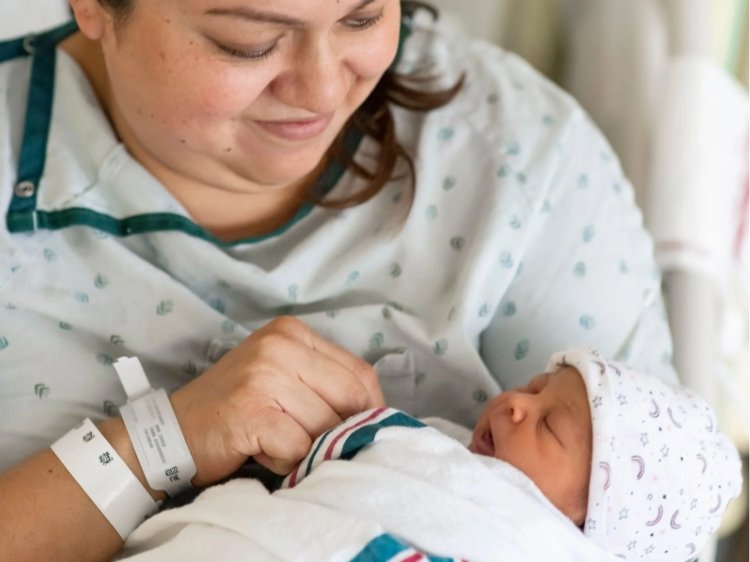 Photo of Hispanic mother holding her newborn baby